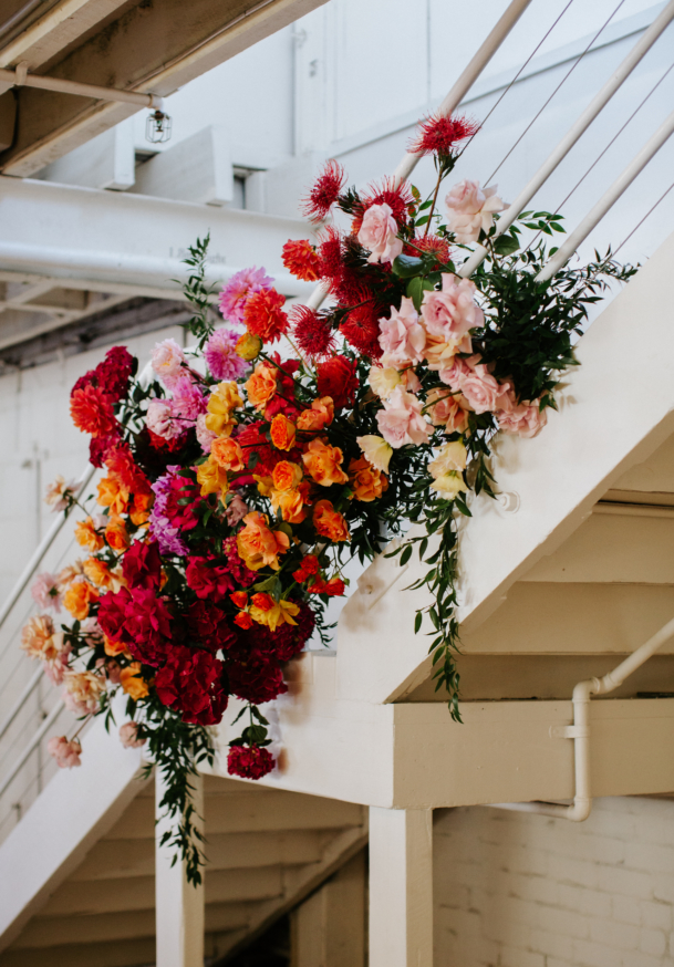 Gather & Tailor staircase cermony florals.